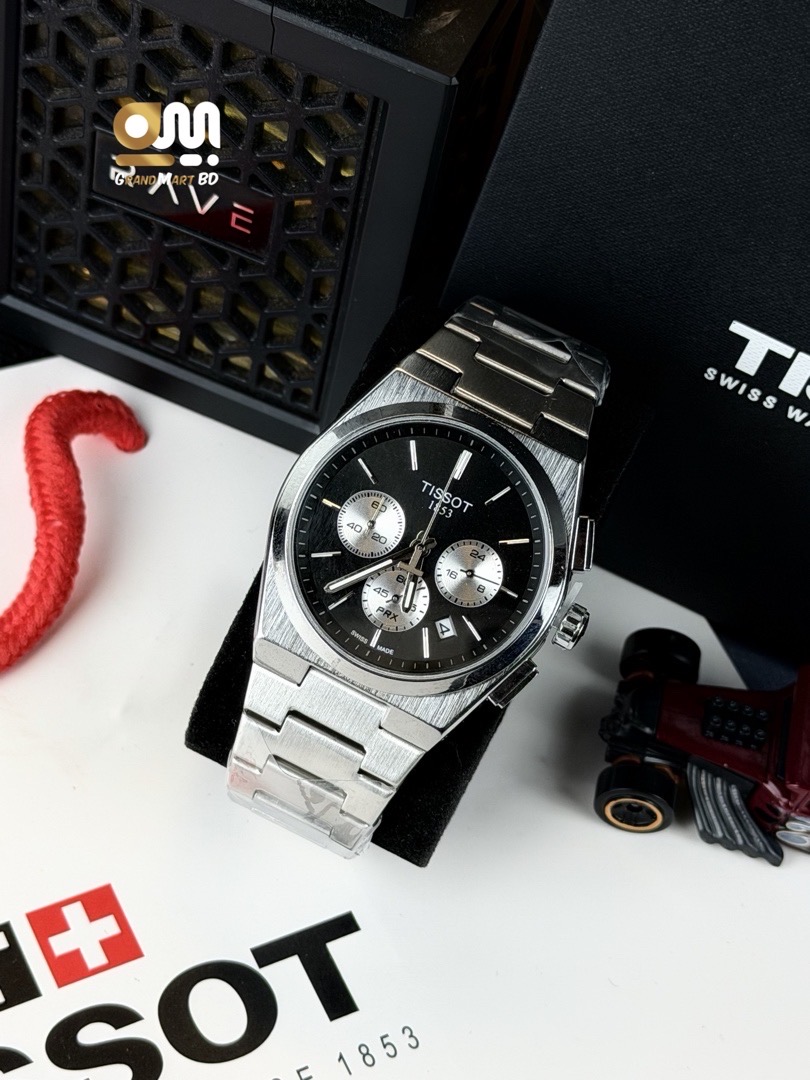 Tissot PRX Chronograph wristwatch featuring a black dial, silver-tone triple-register sub-dials, a stainless steel integrated bracelet, and a quartz movement.