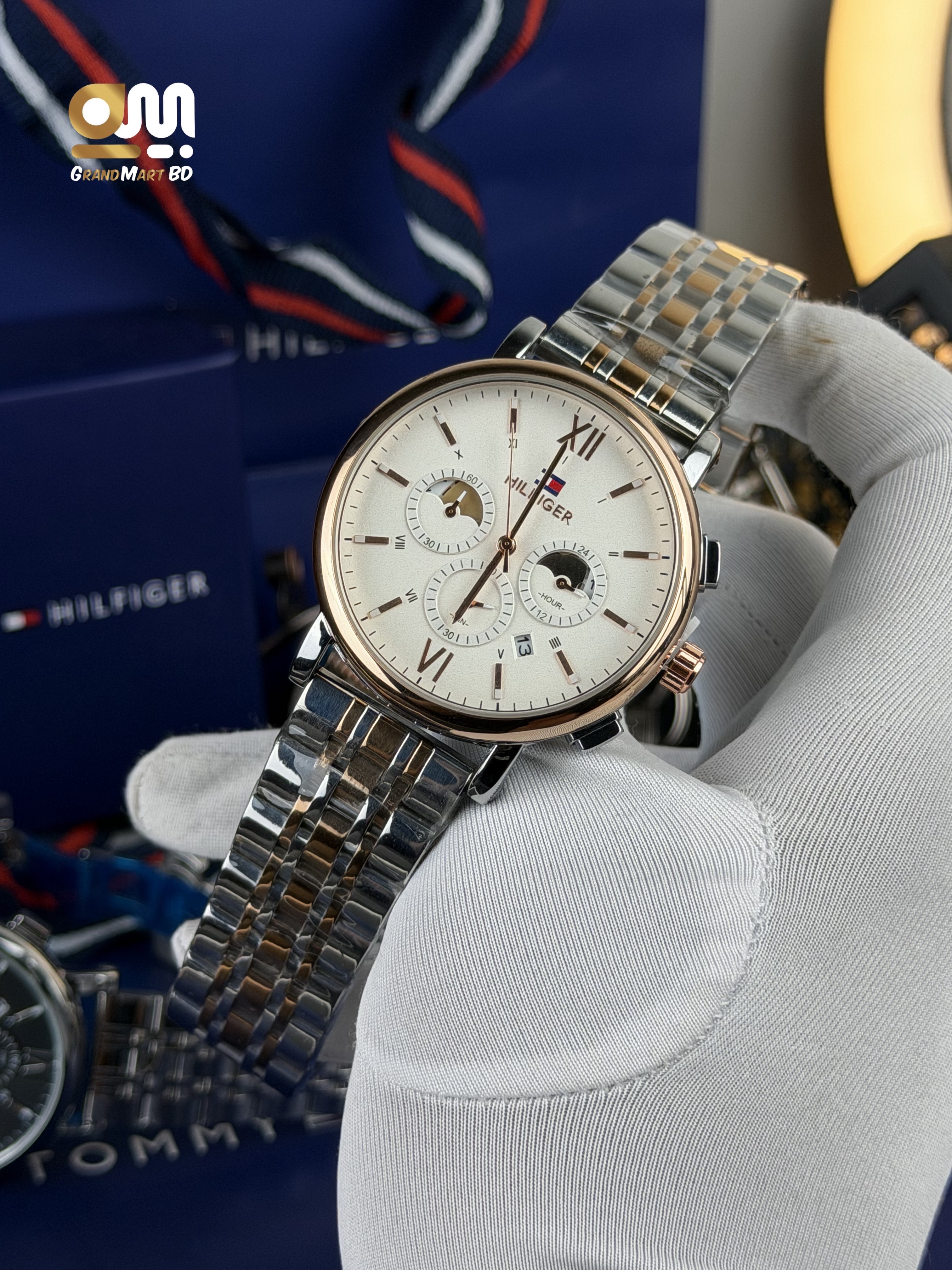 Tommy Hilfiger men's analog wristwatch with a rose-gold-toned bezel, white/cream dial, multi-function sub-dials, and a two-tone stainless steel (silver and rose-gold) link bracelet._img_1
