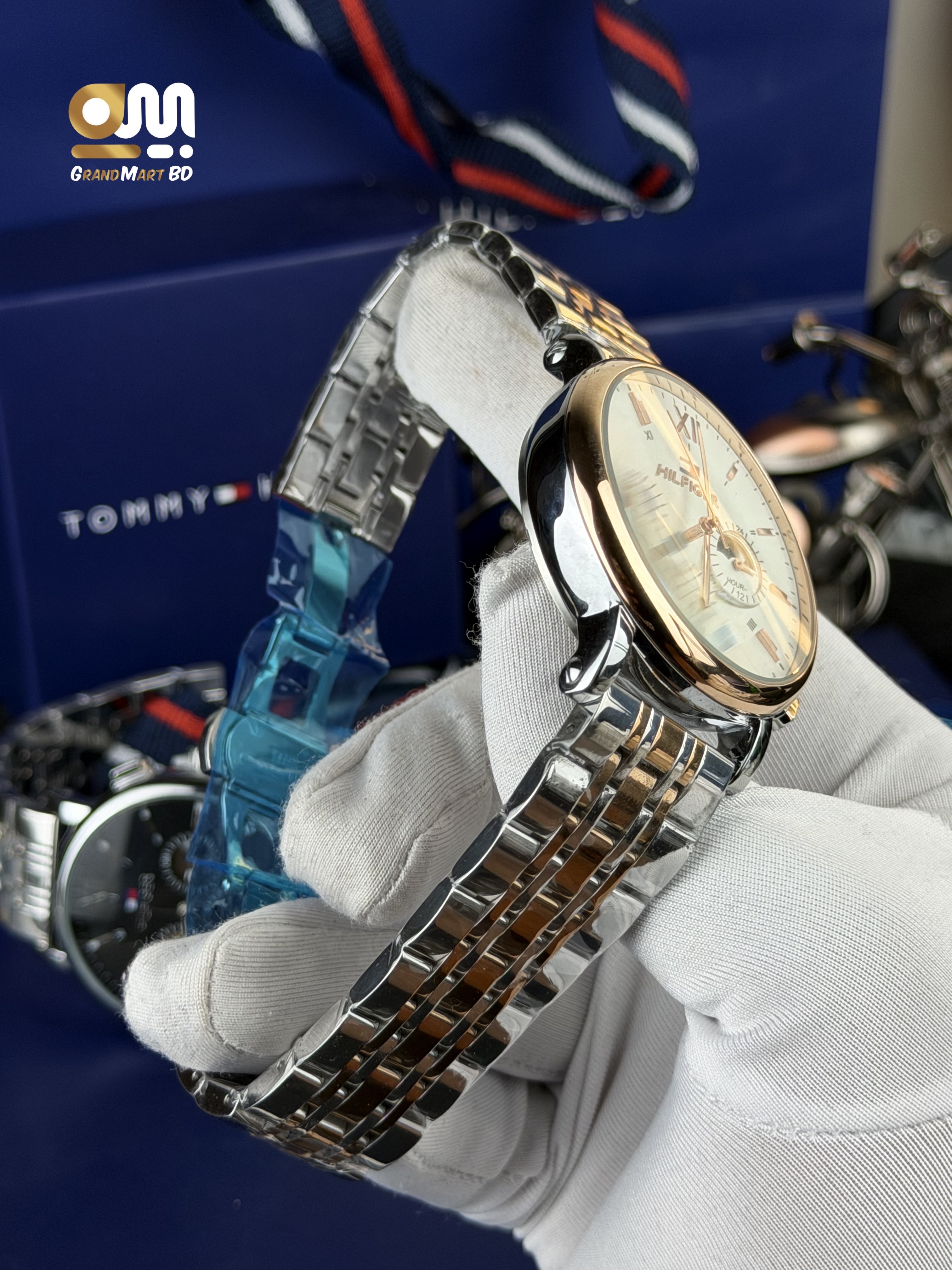 Tommy Hilfiger men's analog wristwatch with a rose-gold-toned bezel, white/cream dial, multi-function sub-dials, and a two-tone stainless steel (silver and rose-gold) link bracelet._img_2