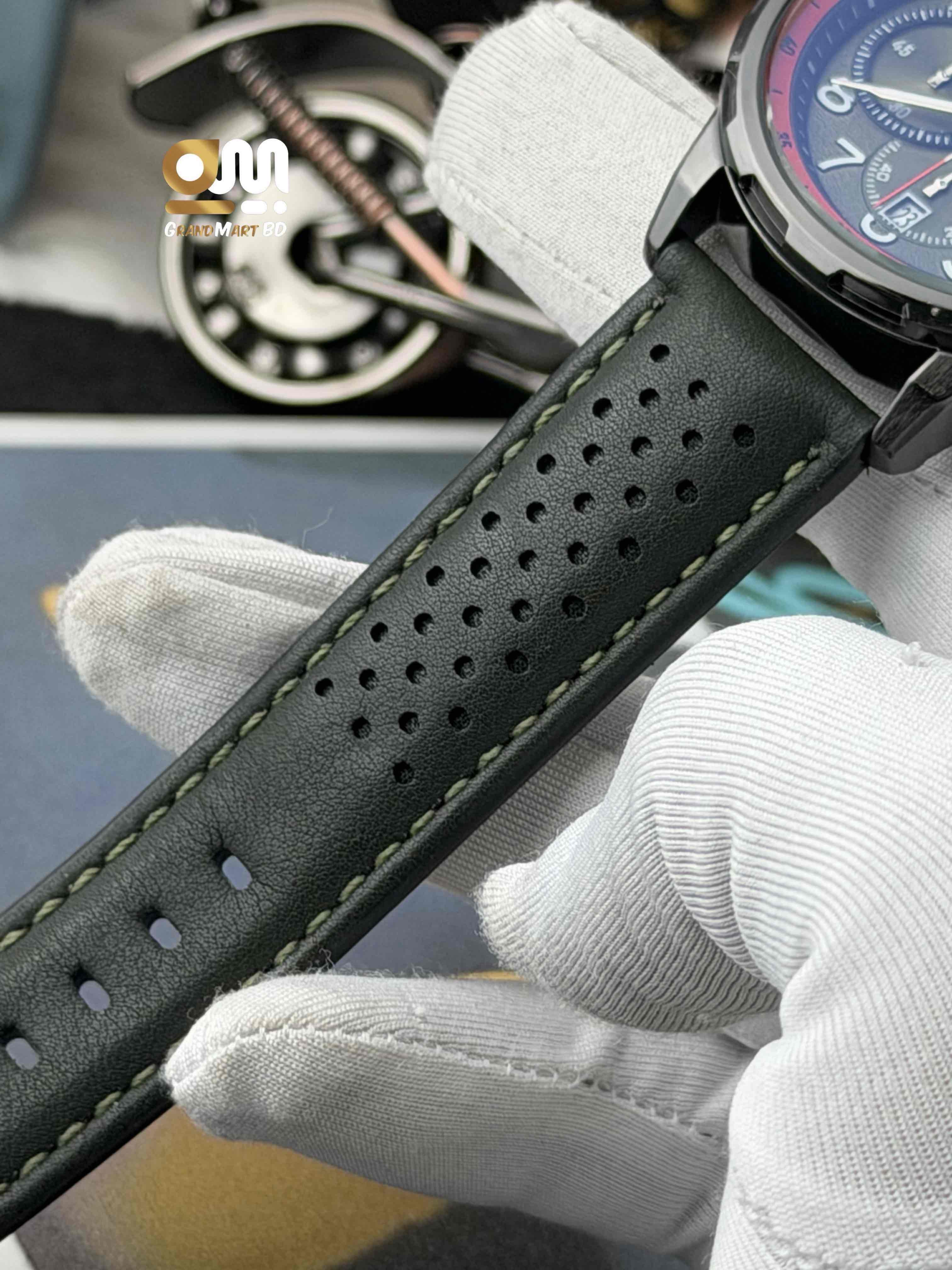 Tubular featuring a black chronograph-style textured dial with numeric markers and a perforated black leather strap._img_1