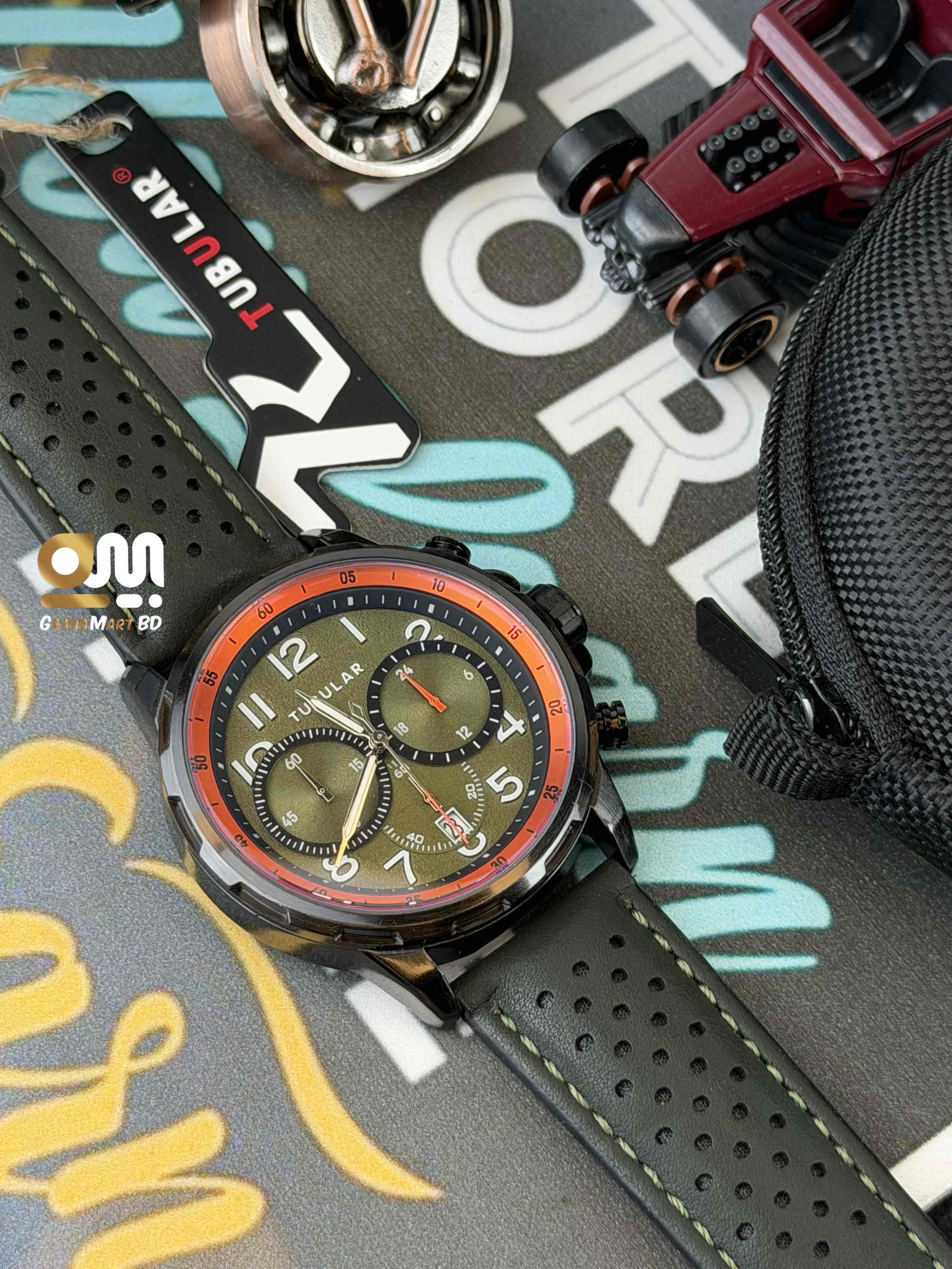 Tubular Chronograph men's sports watch featuring a green textured dial with orange accents and a black perforated leather strap._img_2