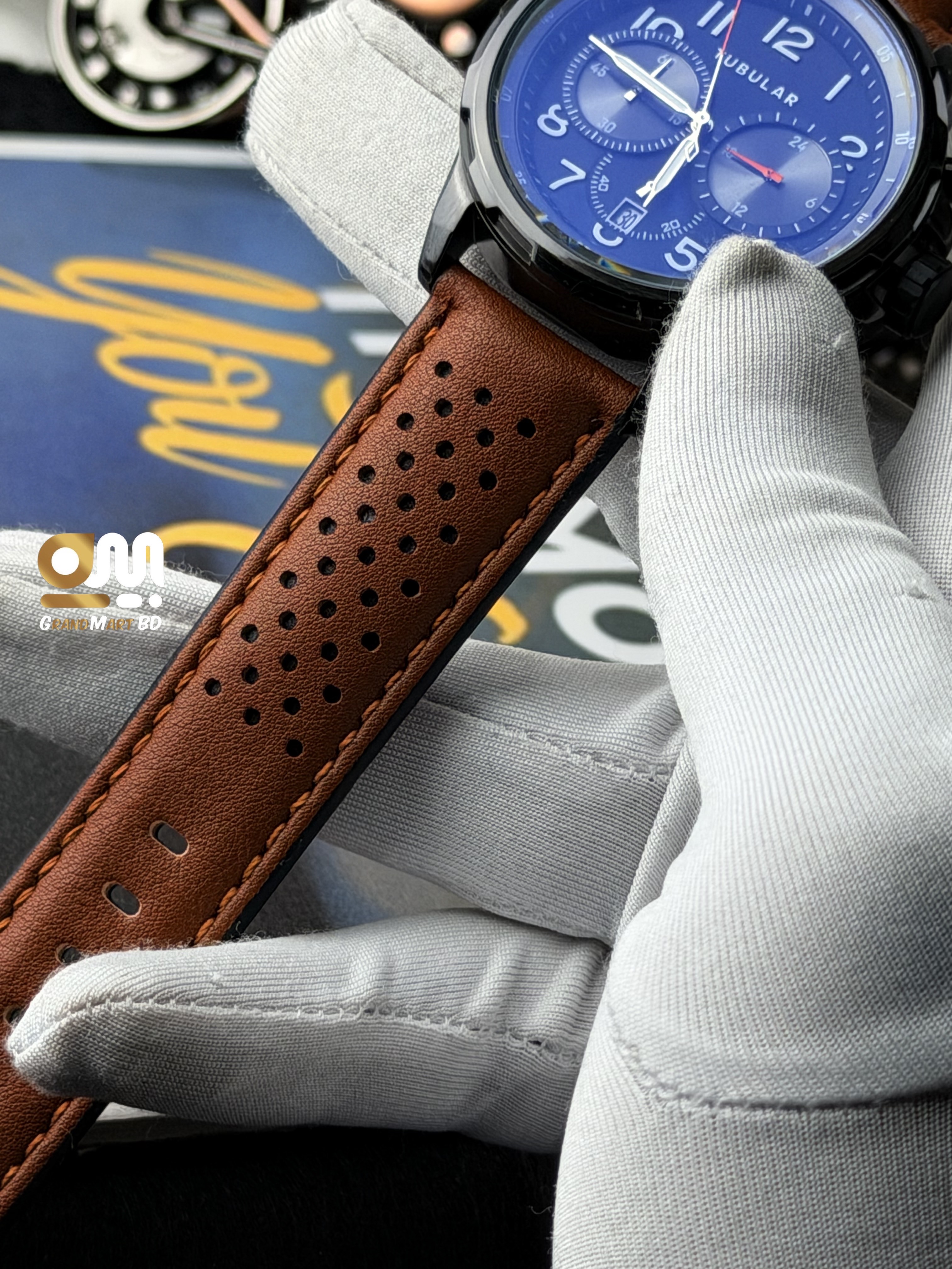 y Tubular chronograph watch stands out with its stylish perforated brown leather strap._img_2
