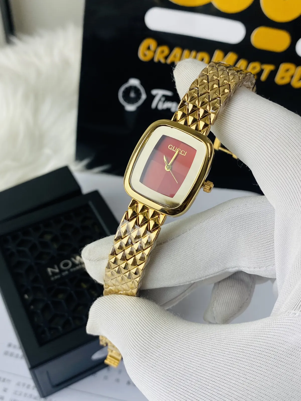 Two-tone Gucci Red dial watch with a square case and a patterned bracelet