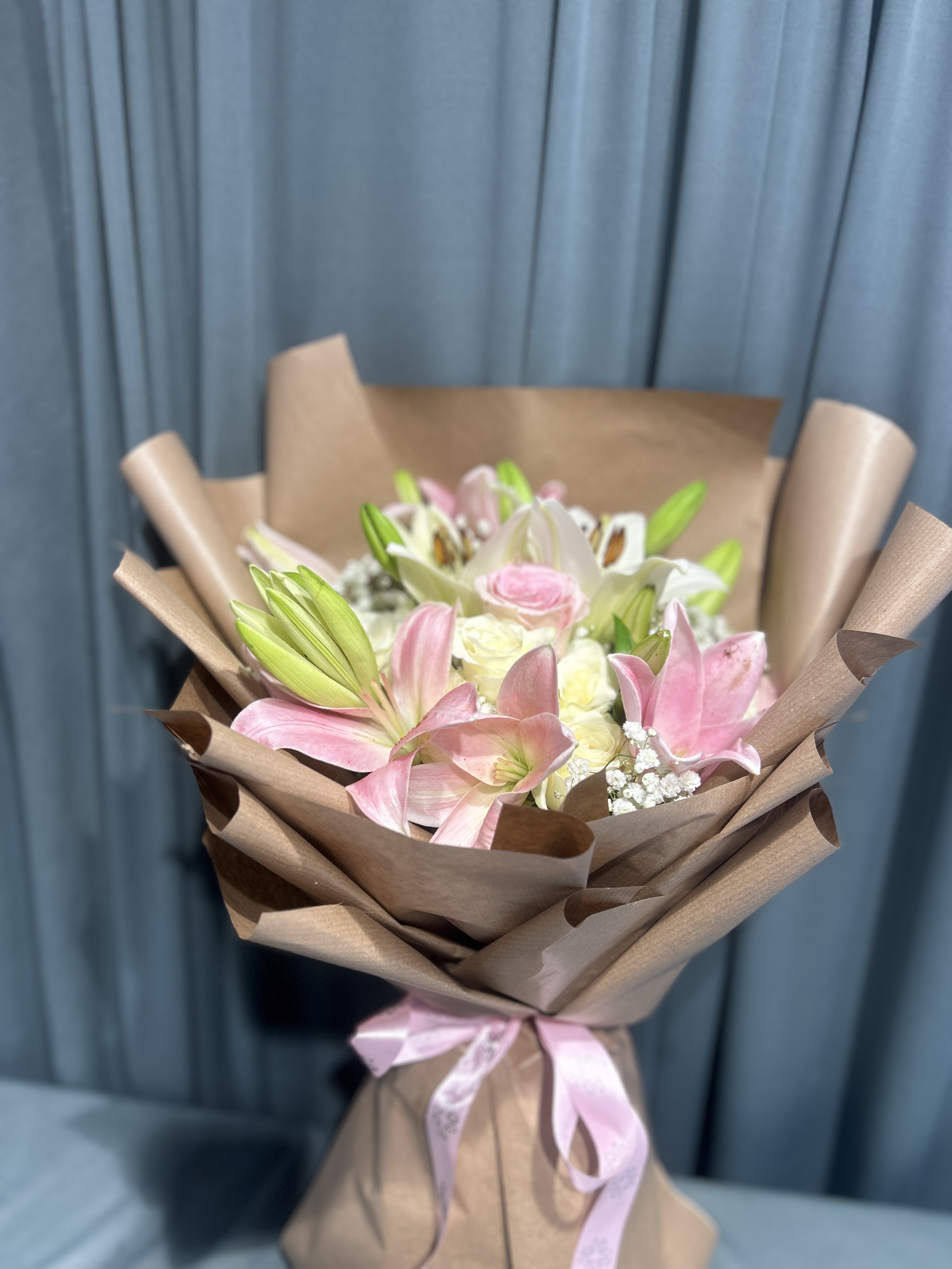 Pink and white lily with roses hand bouquet.