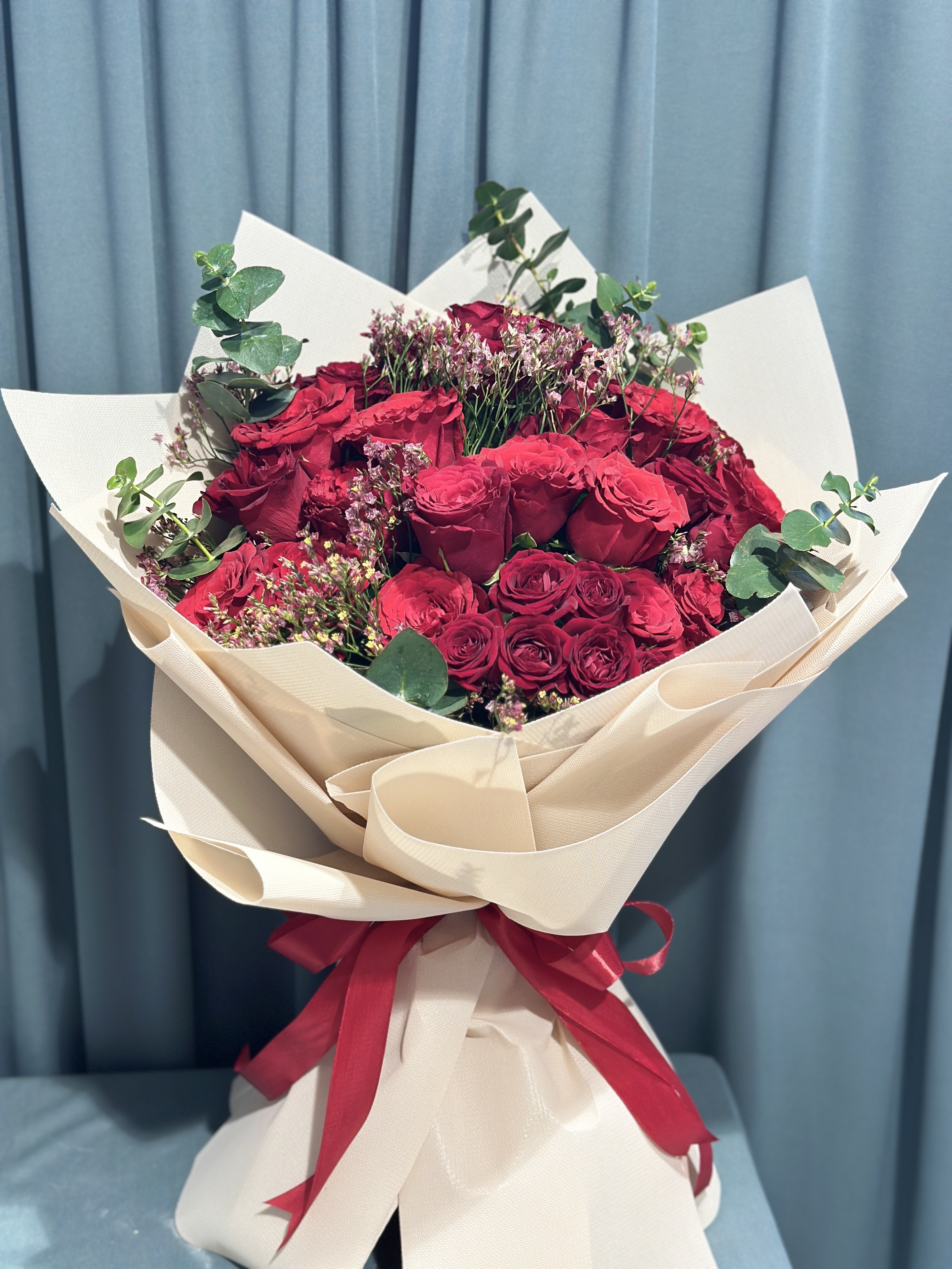 Red rose and baby roses hand bouquet