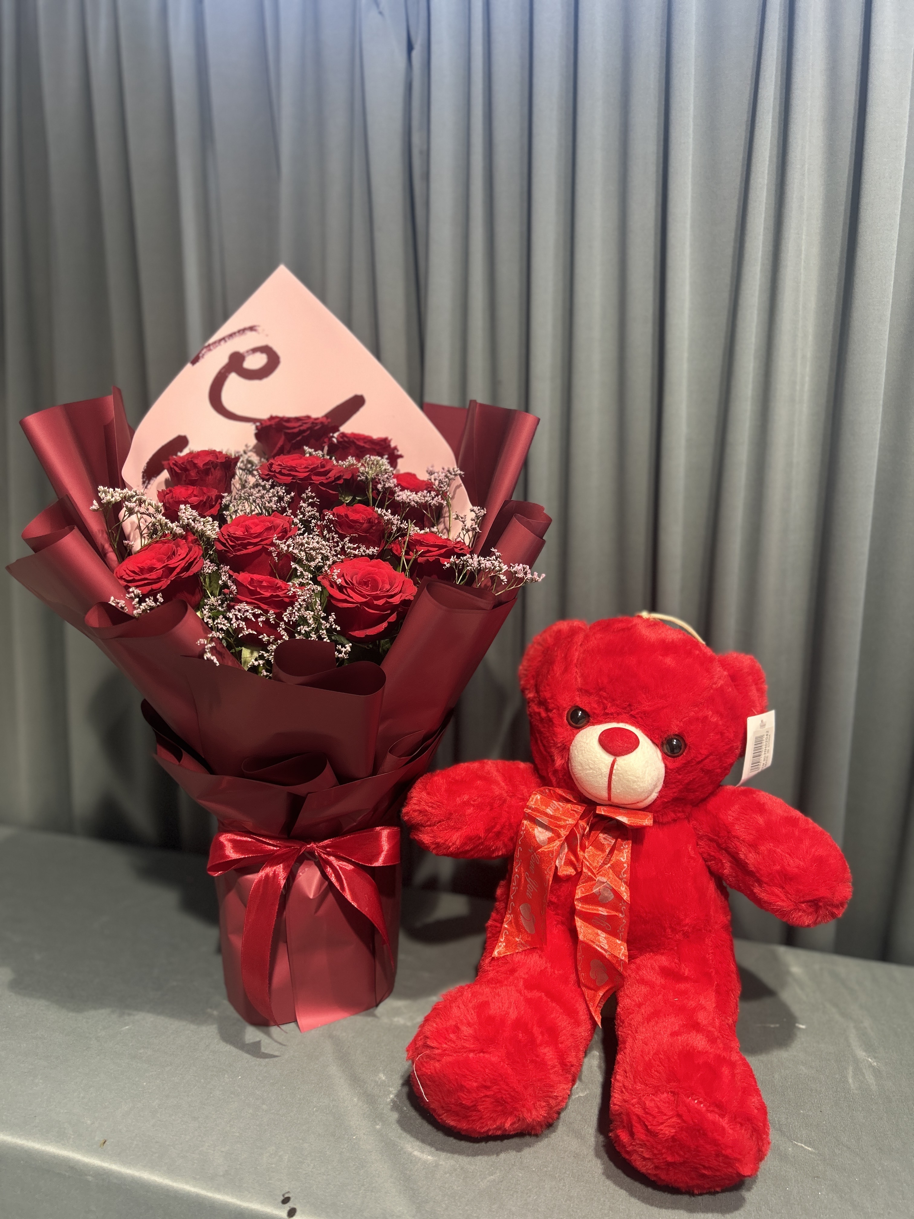 Teddy with red flowers bouquet
