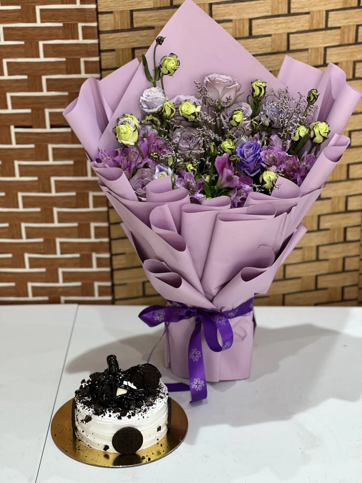 Orio cake with purple flowers stunning bouqu