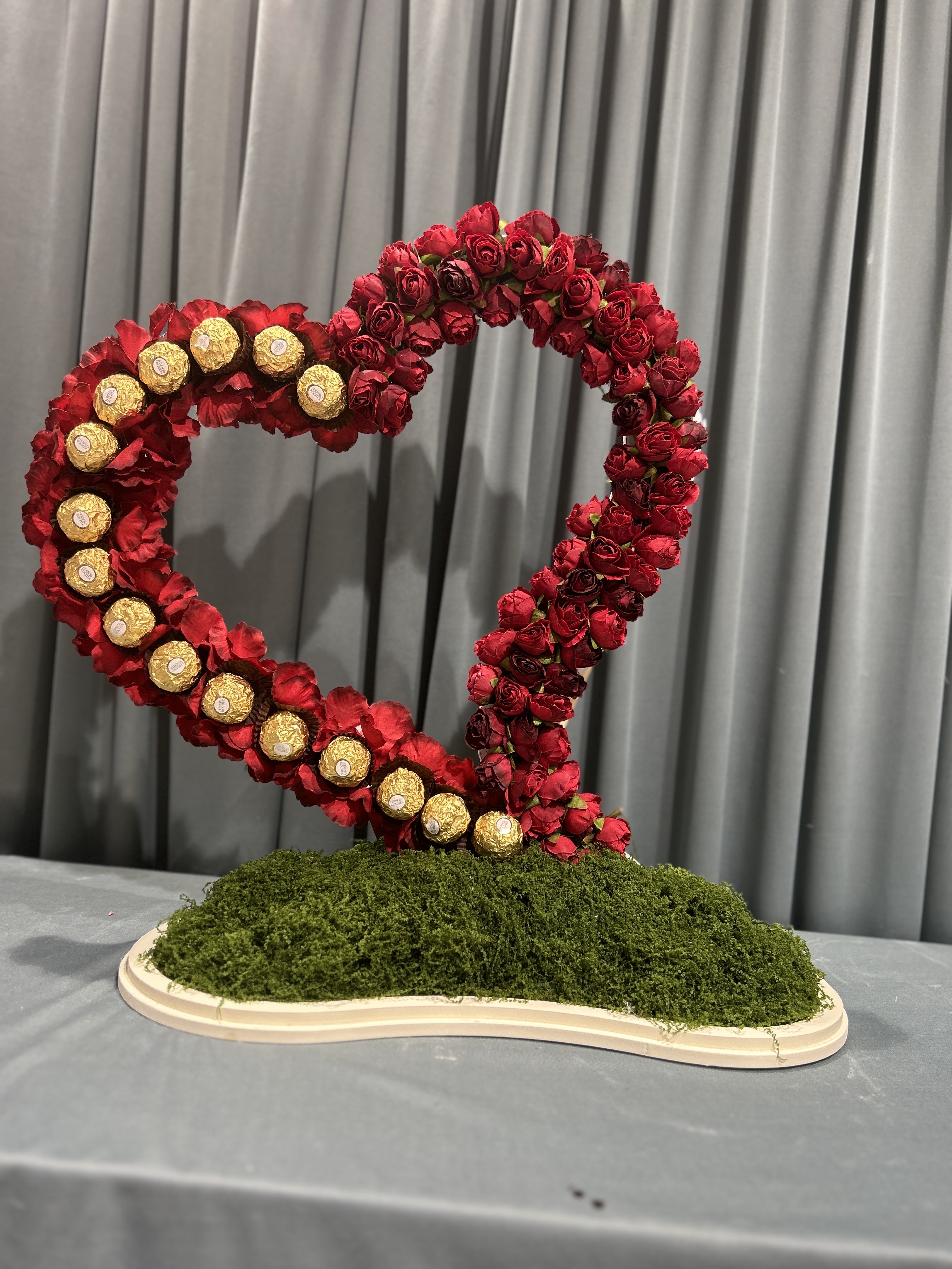 Herat by artificial flowers and Ferrero rocher chocolate