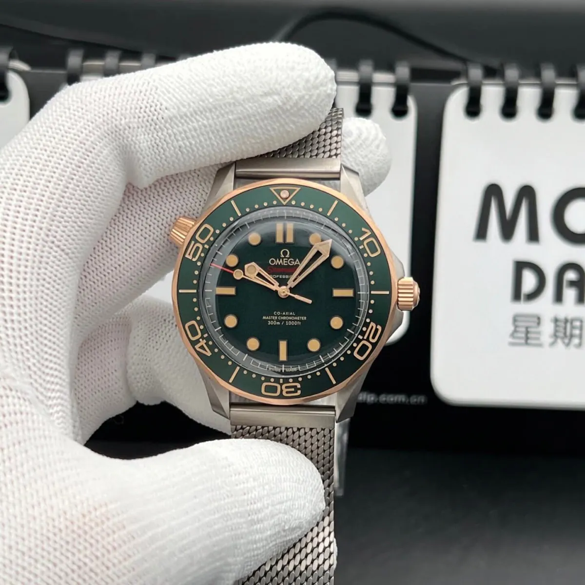 Omega Seamaster Diver 300M – Crafted from Grade 2 Titanium and 9K Bronze Gold, Featuring a Green Aluminum Dial and Matching Bezel with a Mesh Bracelet. Swiss 1:1 Grade (Pre-Order)