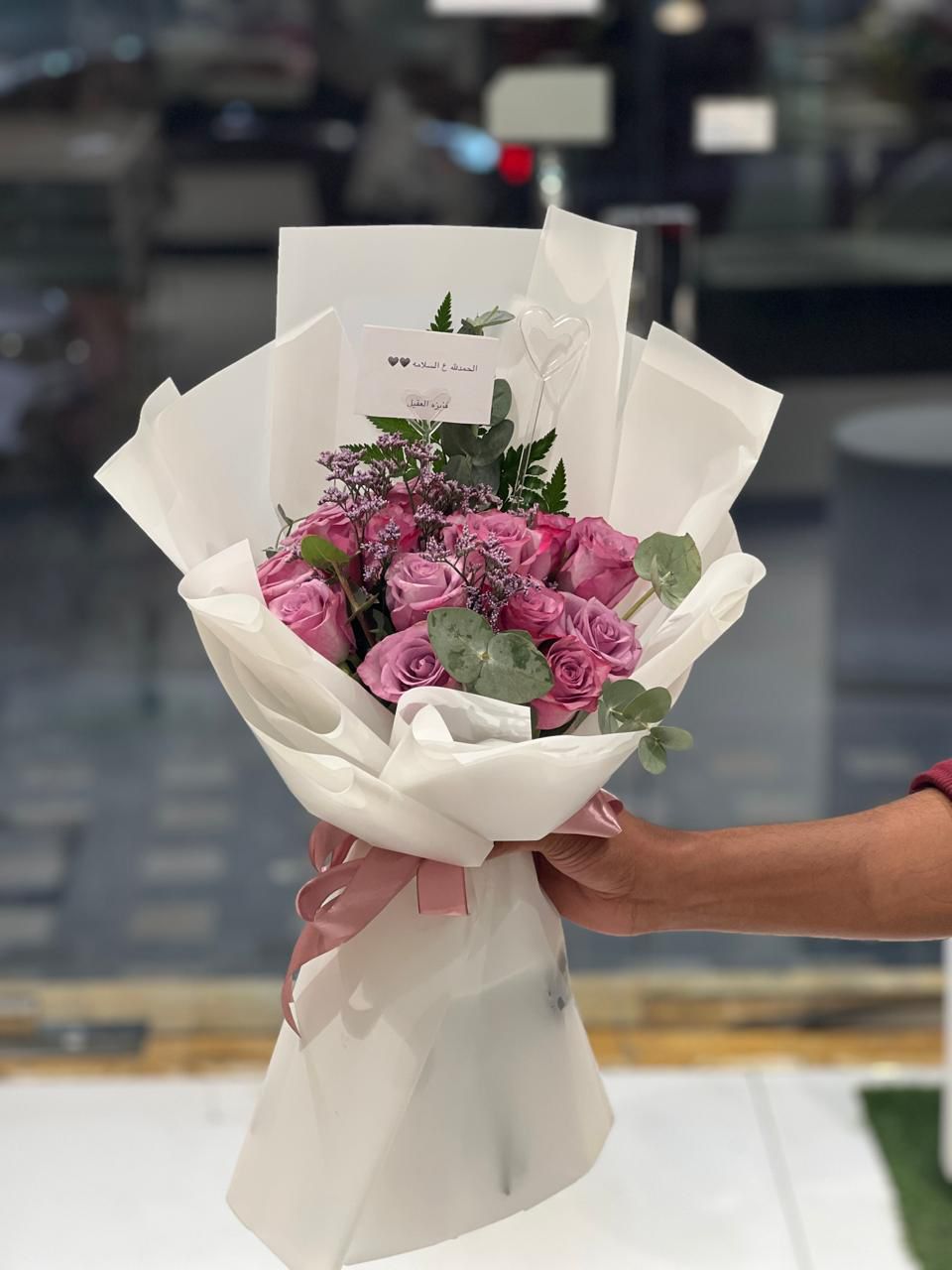 Purple rose hand bouquet