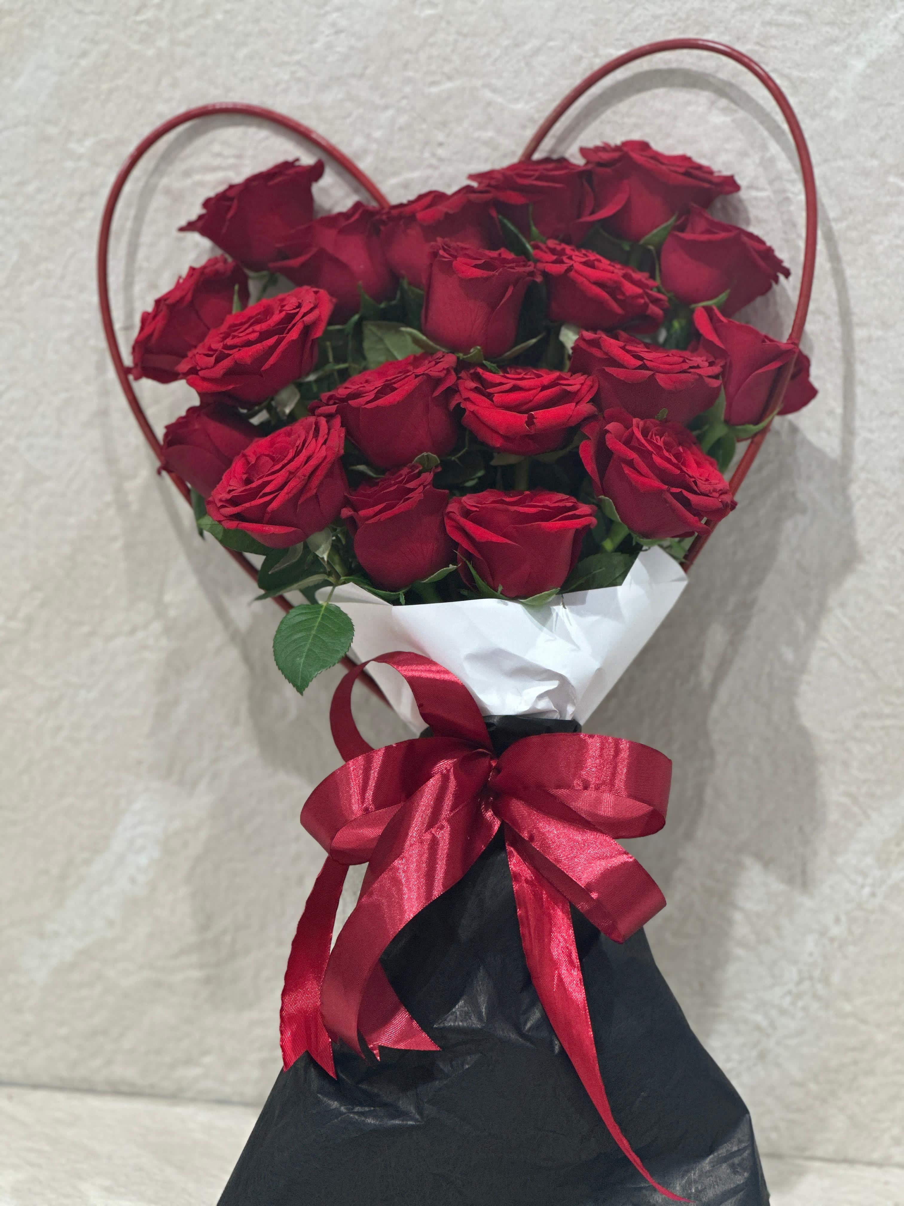 Red roses heart shape hand bouquet