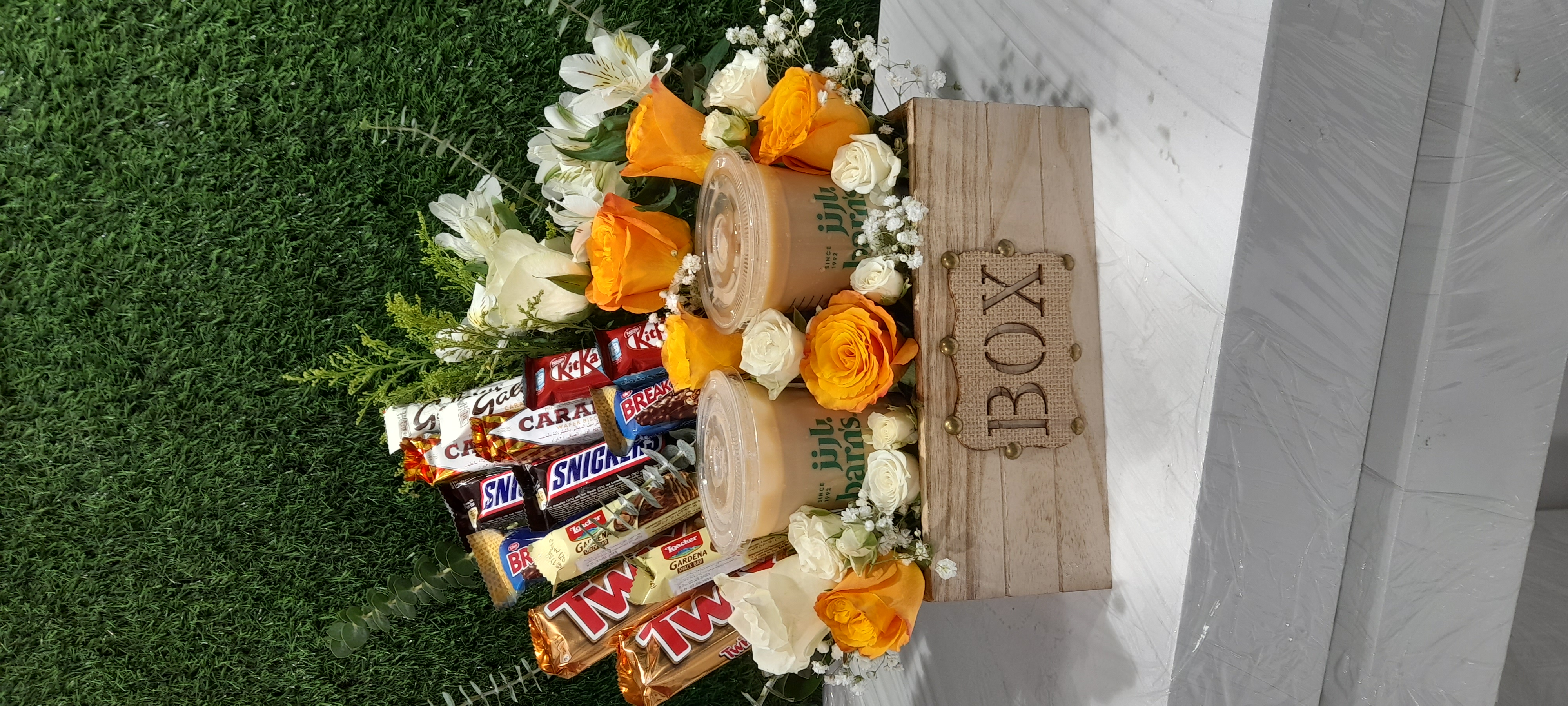 Ice coffee, chocolate & flowers arrangement with in box.