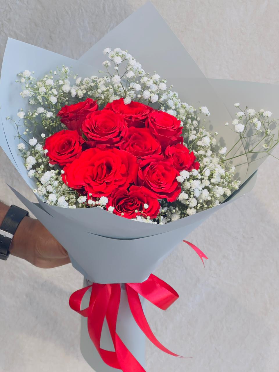 Red roses hand bouquet