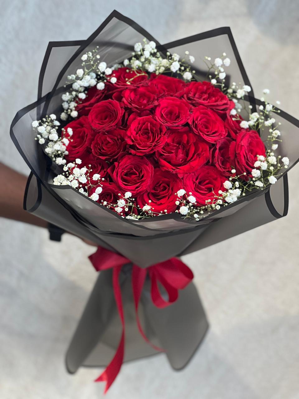 Red roses hand bouquet