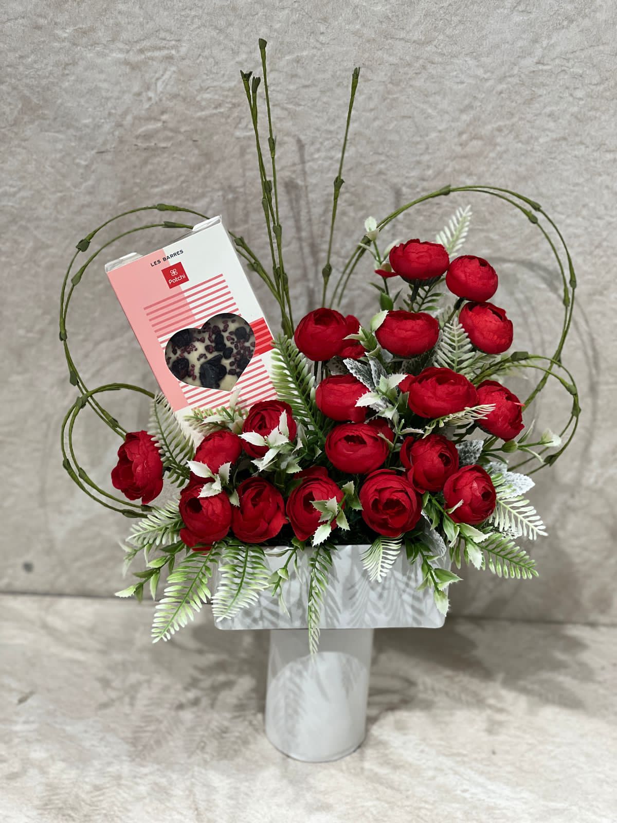 Artificial flowers arrangement with chocolate