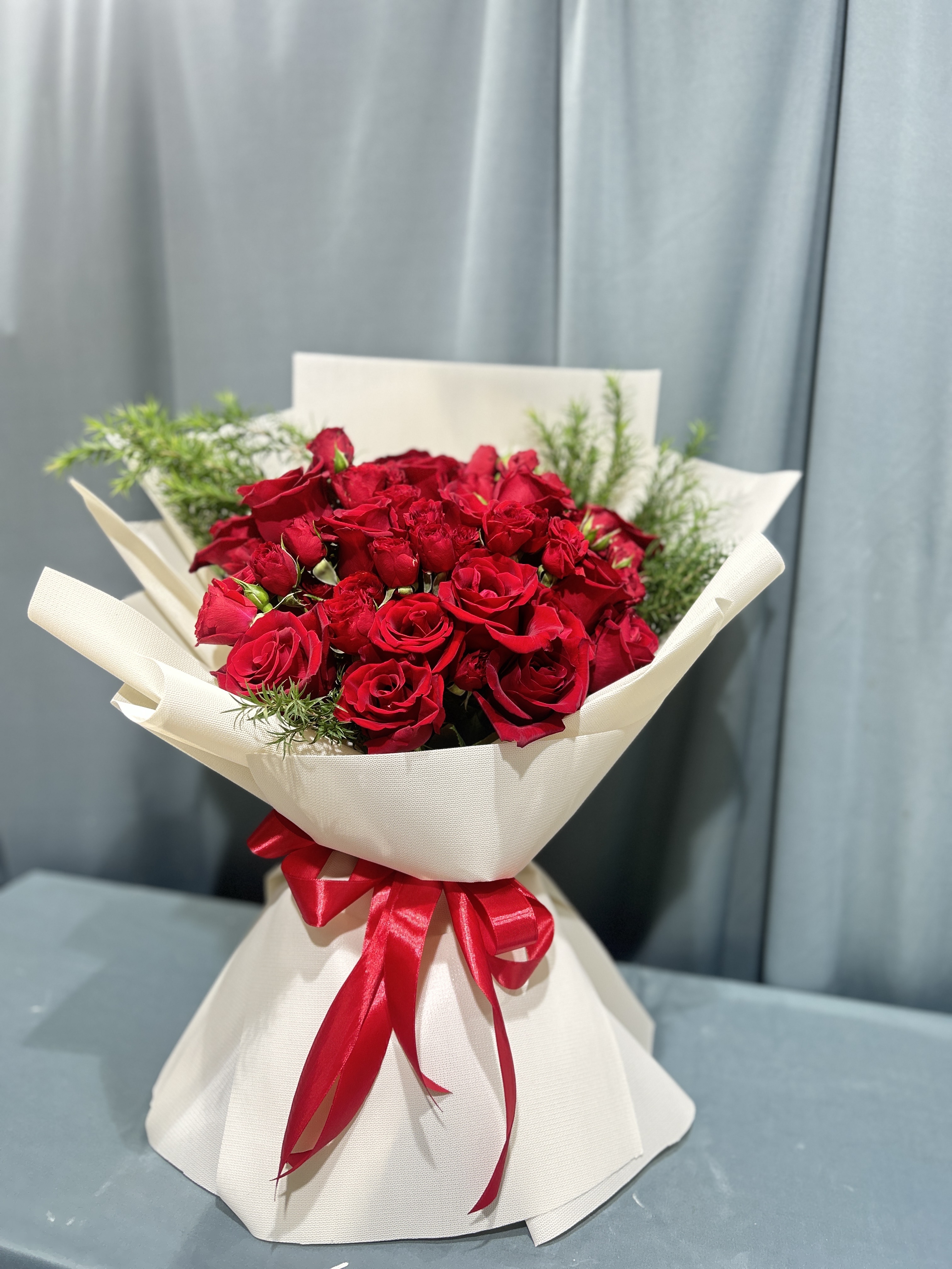 Red roses and baby roses hand bouquet