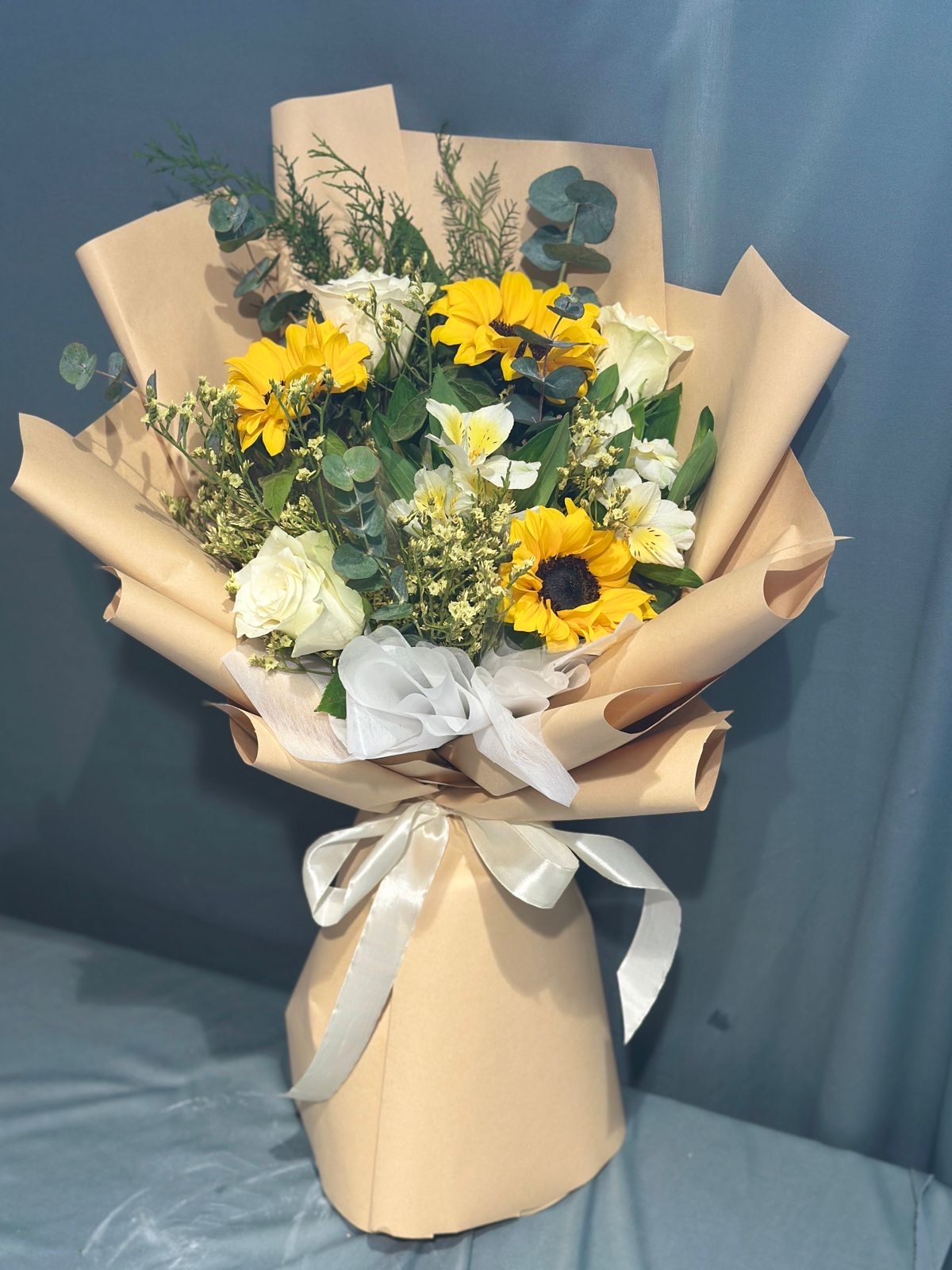 Sunflower with rose and astrameri hand bouquet.
