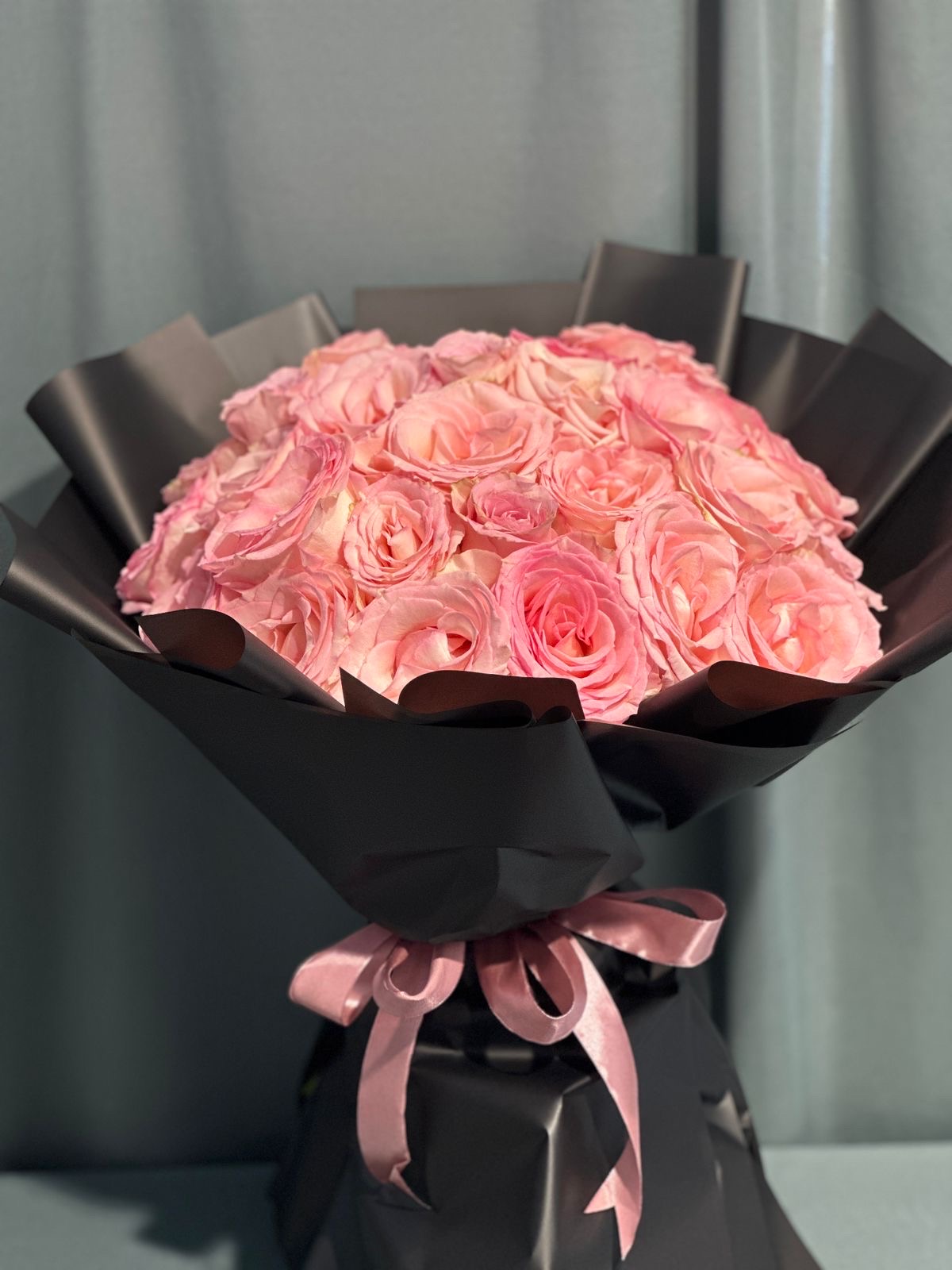 Pink and black hand bouquet .