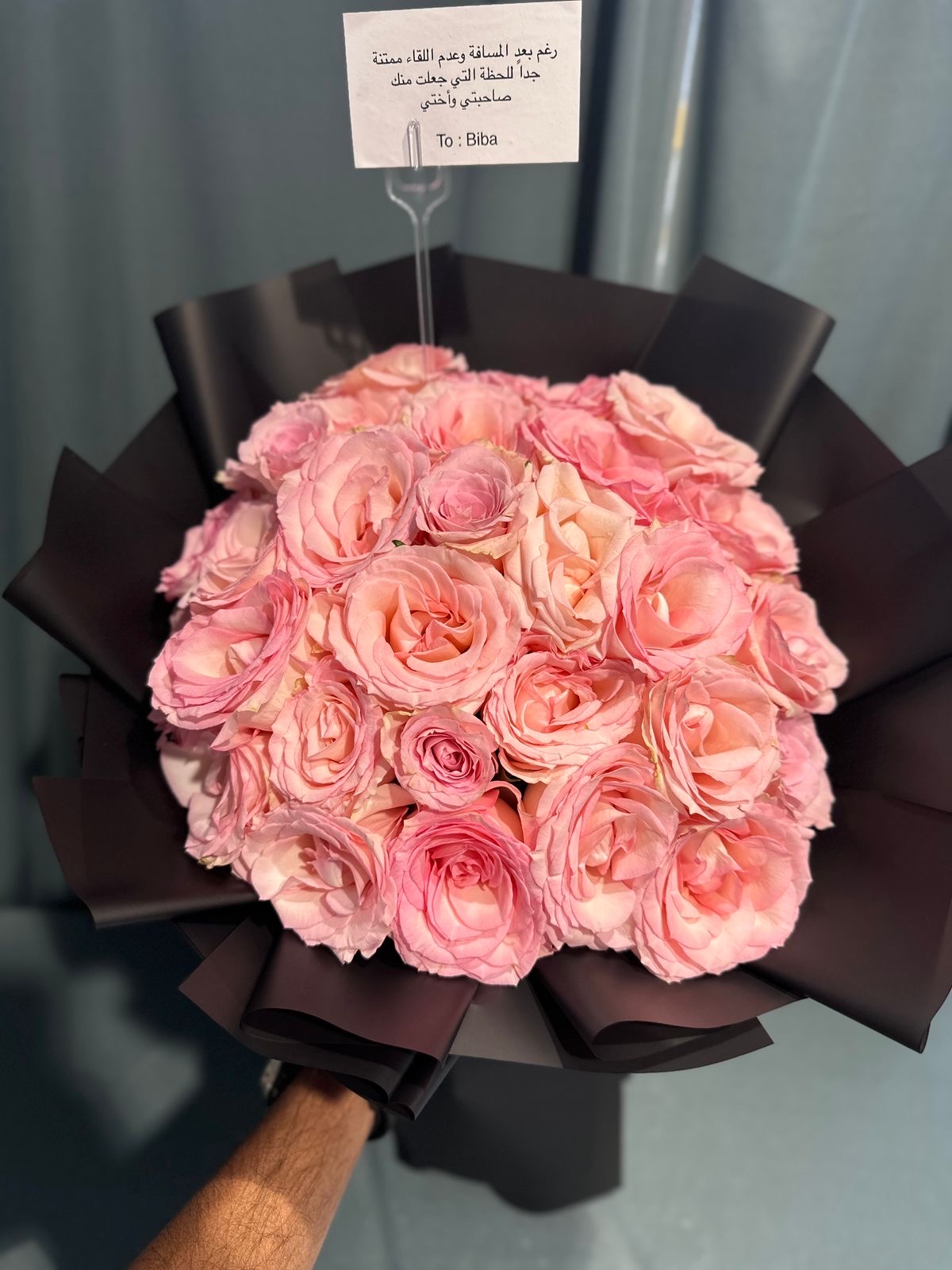 Pink and black hand bouquet ._img_1