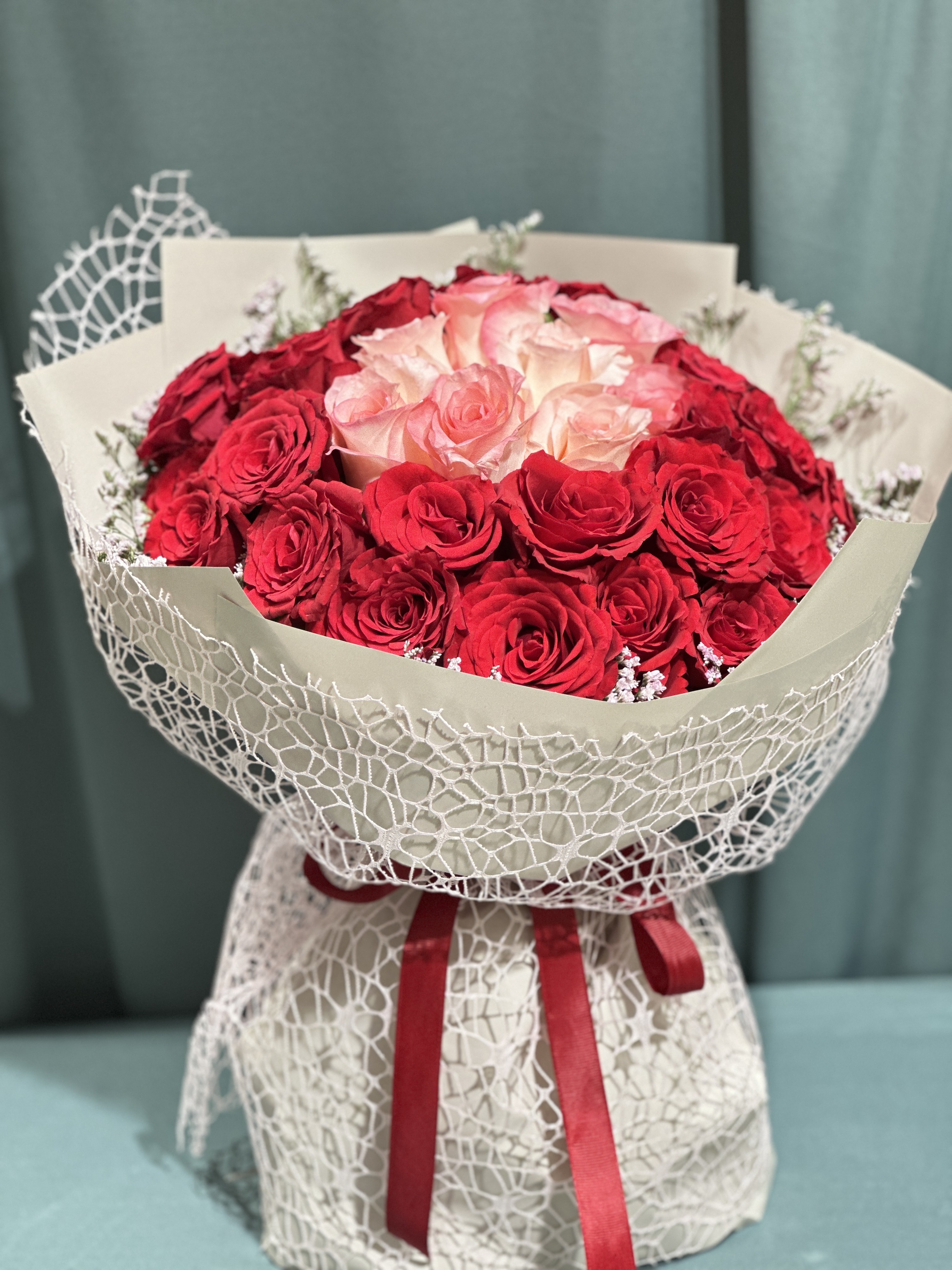 Red and pink roses Hand bouquet